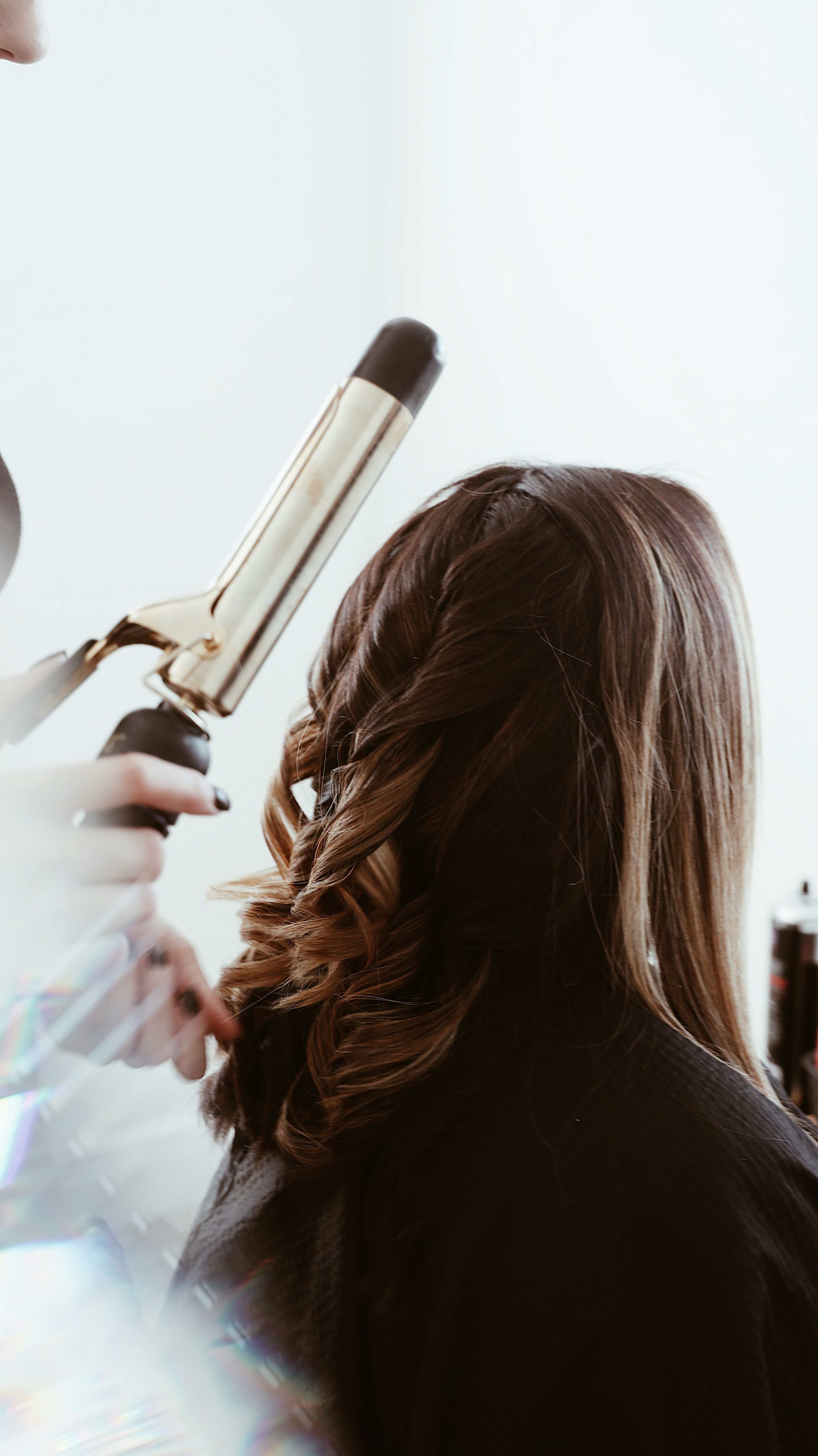 Hair stylist washing someones hair